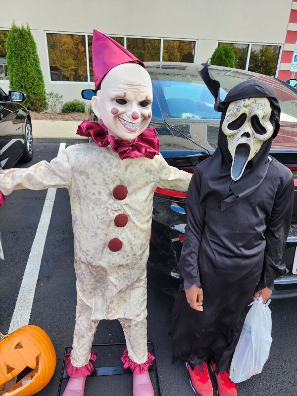 Two kids in scary costumes.