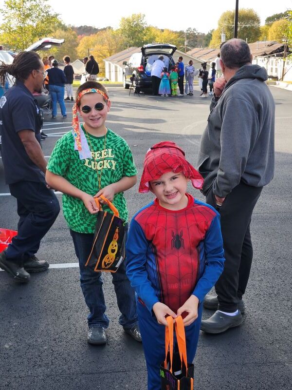 Two kids smile for the camera.